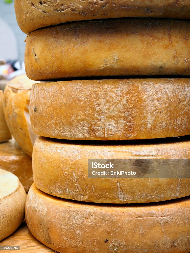 Fontina cheese wheels Street food market. A column of fontina cheese wheels. Valle D'Aosta Stock Photo