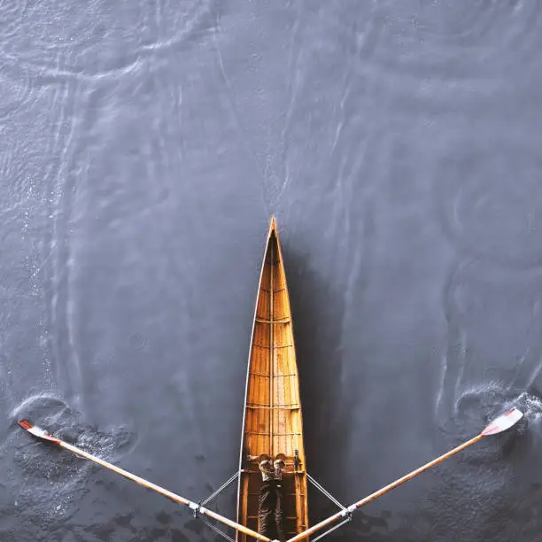 Bird eye view of a rowing boat on the river.