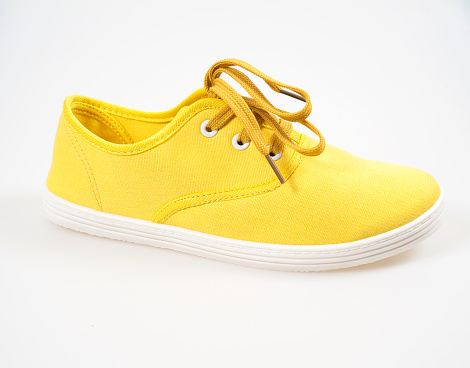 Yellow canvas shoes isolated on white.
