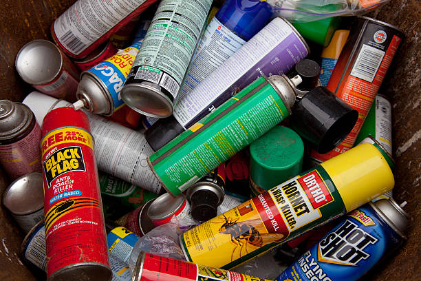 Cans spray Fairfax, VA, USA - December 5, 2013: Bug spray cans gathered in order to be recycled. If there are still contents within the can, they will be properly processed by a household hazardous waste-processing facility. Empty aerosol cans are usually not classified as hazardous waste but rather because their contents are highly pressurized and capable of explosion if heated or otherwise mishandled. aerosol can stock pictures, royalty-free photos & images
