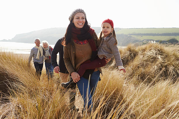 istock Multi Generation Family In Sand Dunes On Winter Beach 502055613