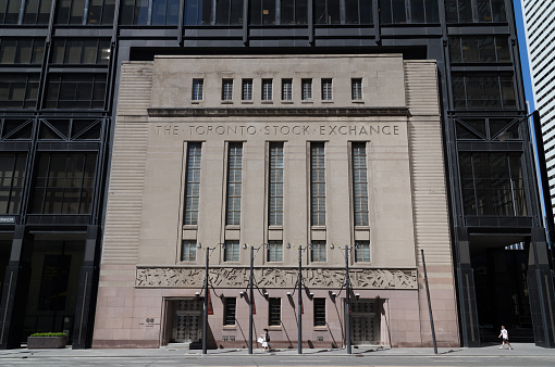 Toronto, Canada - June 22, 2014:The outside of the Toronto Design Exchange located in the historic Stock Exchange building. People can be seen walking outside.