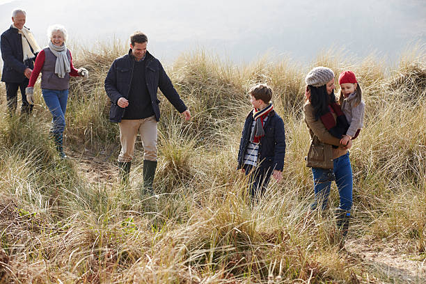 istock Multi Generation Family In Sand Dunes On Winter Beach 502055639