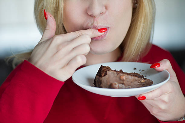 istock Beautiful girl enjoys eating a cake 502056305