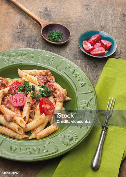 Penne Pasta With Tuna In Green Plate Rustic Stock Photo - Download Image Now - Basil, Bowl, Caper