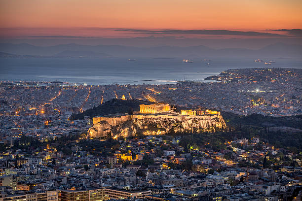 Athens at Night Aerial view over the City of Athens with famous Acropolis at Twilight - Night. Athens, Greece. piraeus photos stock pictures, royalty-free photos & images