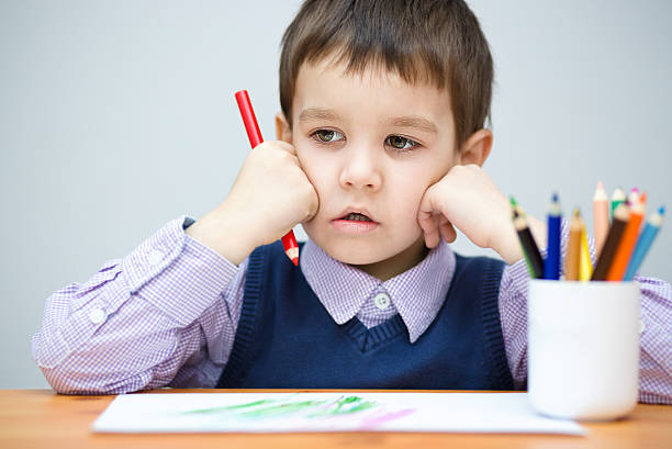 istock Little boy is holding color pencils 502068244