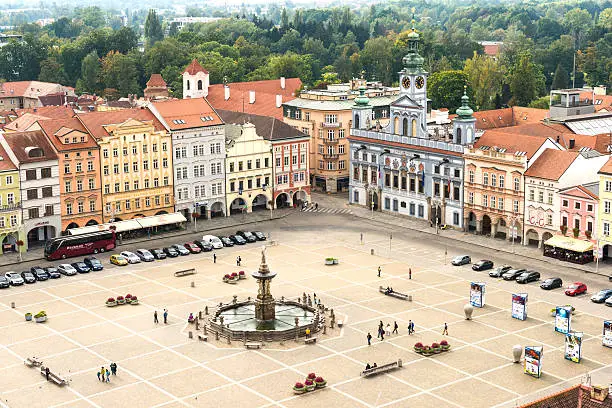 Aerial view on central square of Ceske Budejovice with fountain Samson, some cars parked on square and people walking. Czech Republic