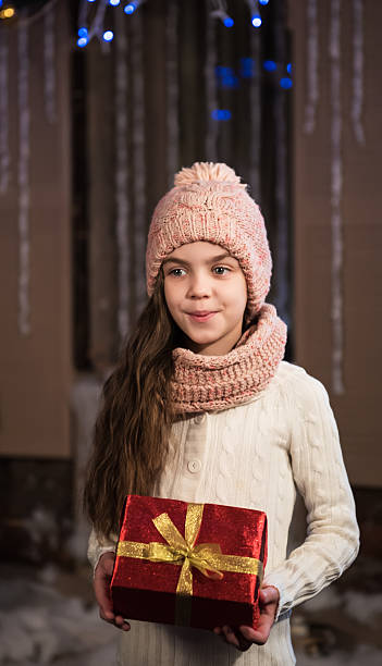 istock girl with christmas gift box 502071726