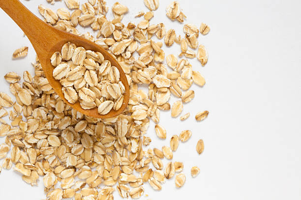 istock Selective focus of oat flakes in spoon on white background 502073966