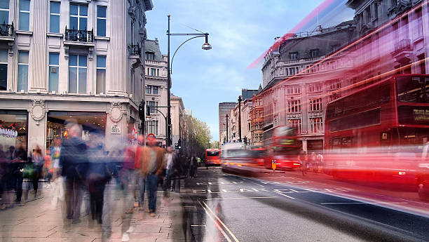 Daytime Long Exposure on Oxford Street Daytime long exposure on Oxford Street near Oxford Circus on a busy weekend afternoon as shoppers walk past and several buses drive by. long exposure stock pictures, royalty-free photos & images