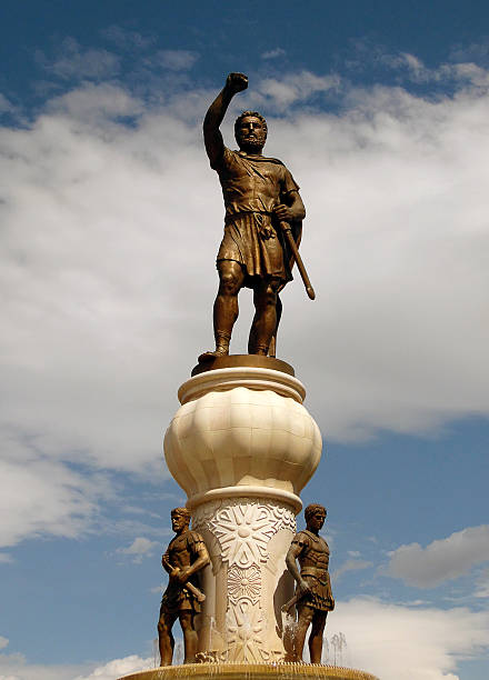 Skopje, Macedonia- September 6, 2015: Poeple in old bazaar in skopje. The view of a giant 29-metre tall bronze statue of the ancient warrior king, Philip of Macedon. “Philip’s 13-metre statue was placed on top of a 16-metre pedestal,” Skopje’s Centar. Itwas built by Zarko Baseski who is a Macedonian sculptor.