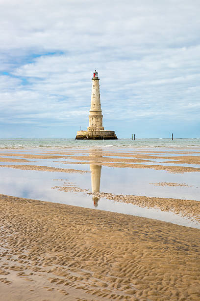 view of Cordouan lighthouse at low tide, Gironde estuary, France view of the historical lighthouse of Cordouan at low tide, Gironde estuary, France estuary photos stock pictures, royalty-free photos & images