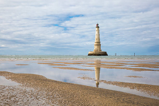 view of Cordouan lighthouse at low tide, Gironde estuary, France view of the historical lighthouse of Cordouan at low tide, Gironde estuary, France beacon photos stock pictures, royalty-free photos & images