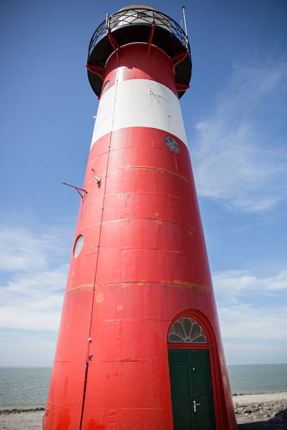 istock Red and white lighthouse, blue sky background, Westkapelle, The Netherlands 502075974