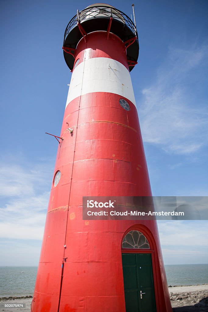 Red and white lighthouse, blue sky background, Westkapelle, The Netherlands Red and white lighthouse on a blue sky background, Westkapelle, The Netherlands 2015 Stock Photo