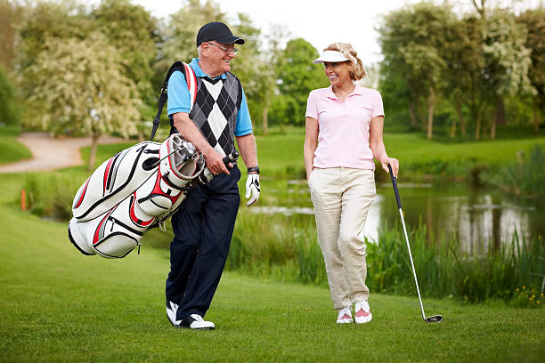 istock Senior couple playing golf walking down the course 502087257