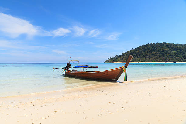 istock Boat on the beach with blue sky 502087313