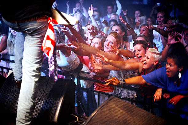 istock Reaching out towards their music idol 502088181