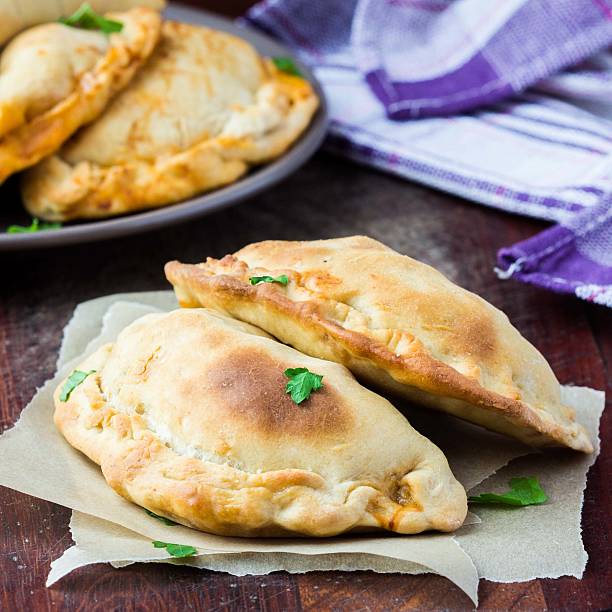 istock Mini calzone, closed pizza, Italian pastry stuffed with cheese 502088629