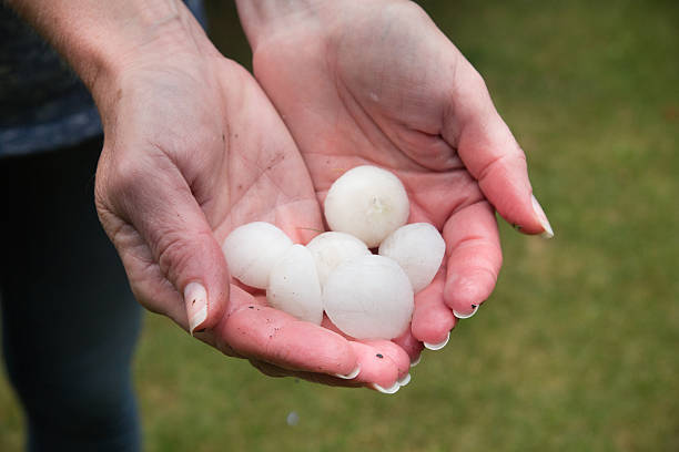 Hail in hands stock photo