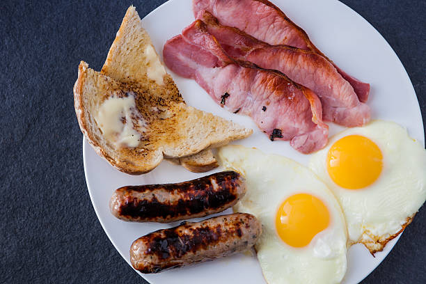 istock Englsih breakfast with bacon, pork and apple sausages 502091799