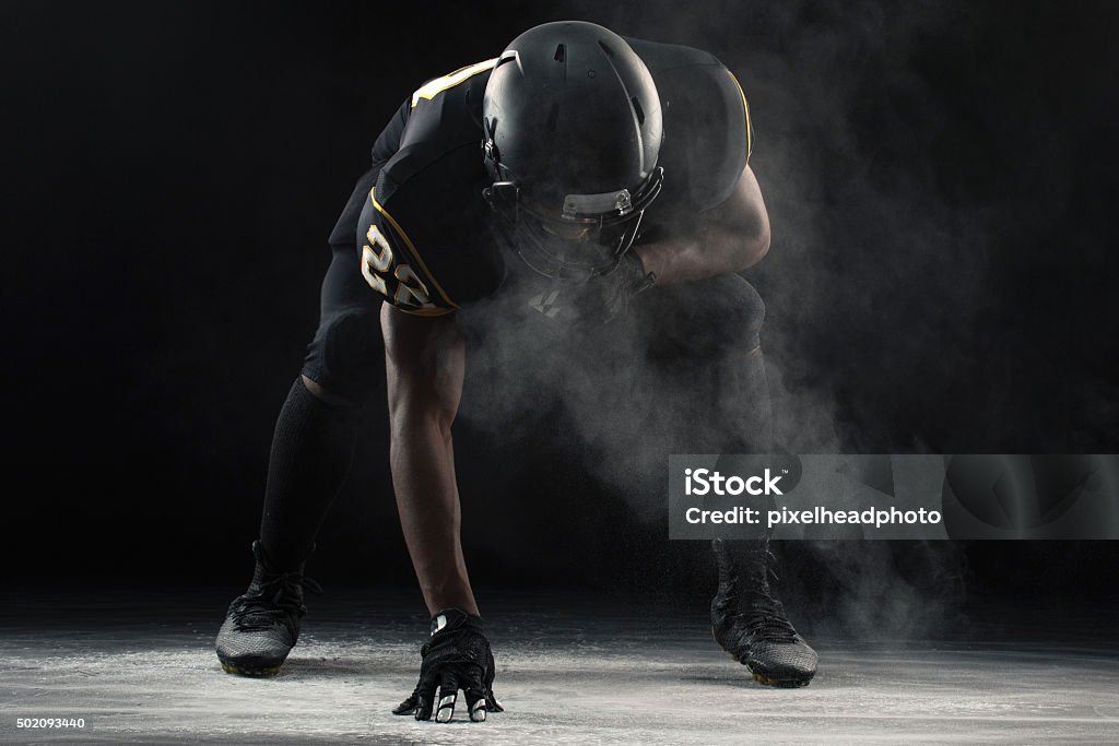 American Football Football player in a three-point stance. American Football Player Stock Photo