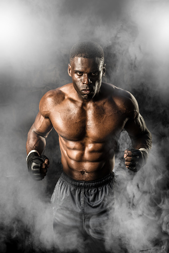 MMA Fighter On A Smokey  Background ready to fight.