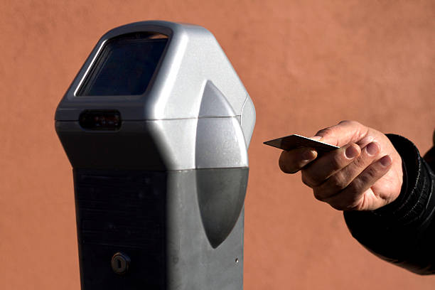 istock Hand Ready to Swipe Card at Parking Meter (Close-Up) 502098078