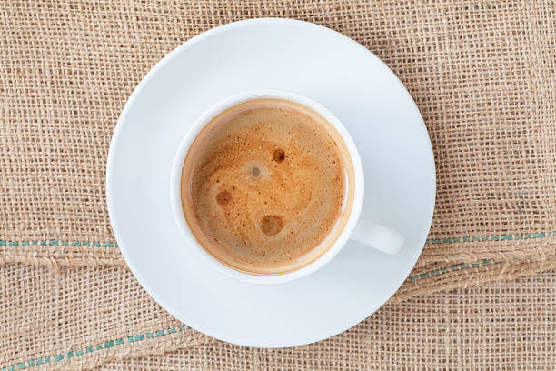 istock Cup of hot coffee on brown fabric 502098592