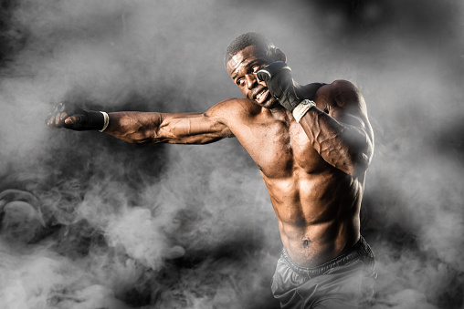 MMA Fighter On A Smokey  Background ready to fight.MMA Fighter On A Smokey  Background ready to fight.
