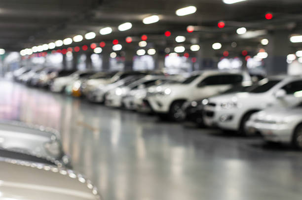 istock blurred car parking with bokeh light Background 502099948