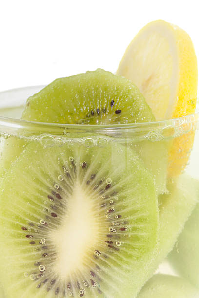 Kiwi fruit and lemon slice with soda water Kiwi fruit and lemon slice with soda water make detox water recipe soda water glass lemon stock pictures, royalty-free photos & images