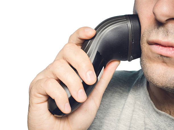 istock man shaving his beard off with an electric shaver 502102080
