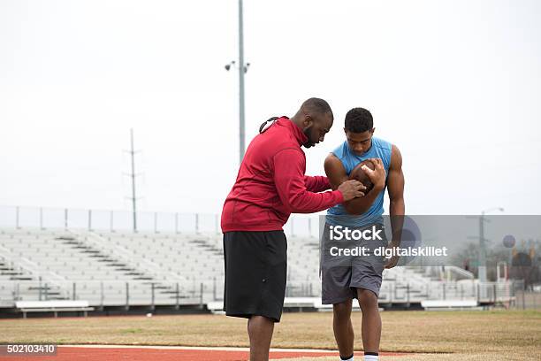 Coach Training A High School Athlete For Football Stock Photo - Download Image Now - Coach, Athlete, American Football - Sport