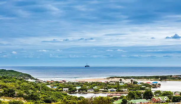 Mossel Bay with an oil rig in the distance, the lagoon below where the Hartenbos river meets the sea. Holiday resort seen below.