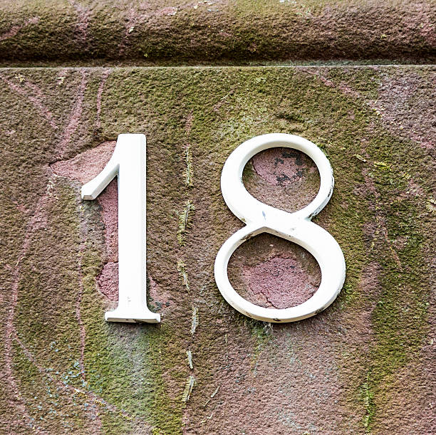 istock House number eighteen, deteriorated white lettering. 502115167