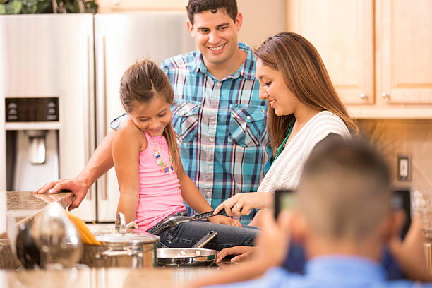 istock Hispanic family cooking dinner together in home kitchen. 502115833