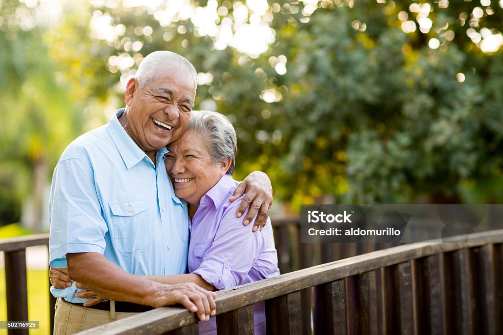 Mexican senior couple laughing on bridge A mexican senior couple laughing together on bridge. Senior Adult Stock Photo
