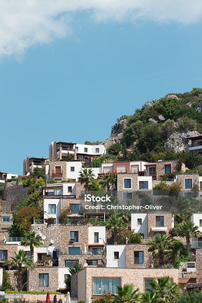 Flat Roof Houses Roofless houses built on a hill with palm trees. Apartment Stock Photo