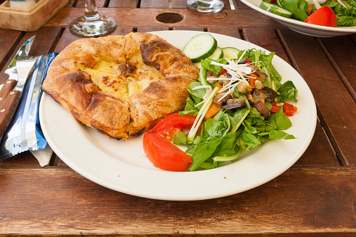 A dish with flaky pastry cake, salads and tomatoes in Malta