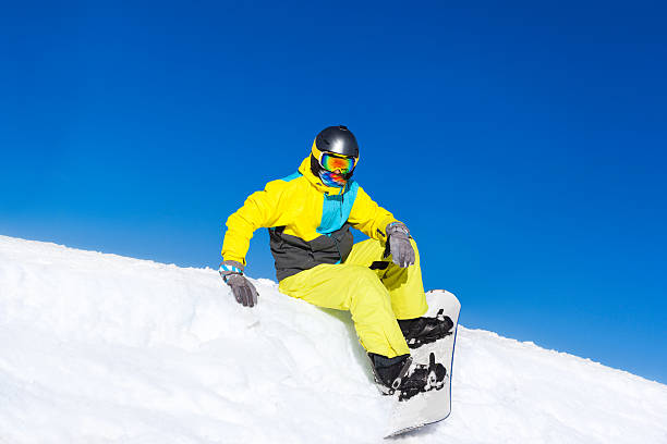 istock Snowboarder sitting on snow mountains 502118017