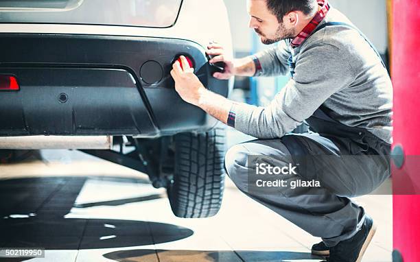 Car Mechanic At Work Stock Photo - Download Image Now - Bumper, Car, Repairing