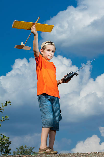 istock Little boy playing with handmade RC airplane toy 502124700