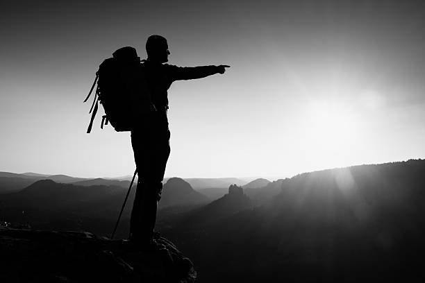 istock Sharp silhouette on mountain with sun. Tourist guide in workday 502125752