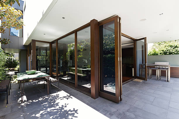 Bi fold doors opening to rear courtyard of contemporary home stock photo