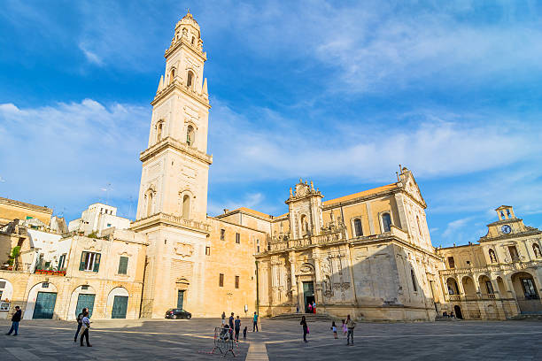 Lecce, Italy - May 16, 2015: day view of Piazza del Duomo square with tourists and Cathedral in Lecce, Italy. Lecce is the main city of the Salentine Peninsula, a sub-peninsula at the heel of Italy.