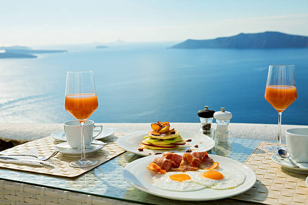 Fresh Breakfast near the sea Fresh juice and Breakfast on the shore of the blue sea, Greece, Santorini. table ledge stock pictures, royalty-free photos & images