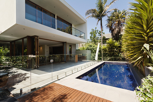 Rear garden of a contemporary Australian home with tiled swimming pool