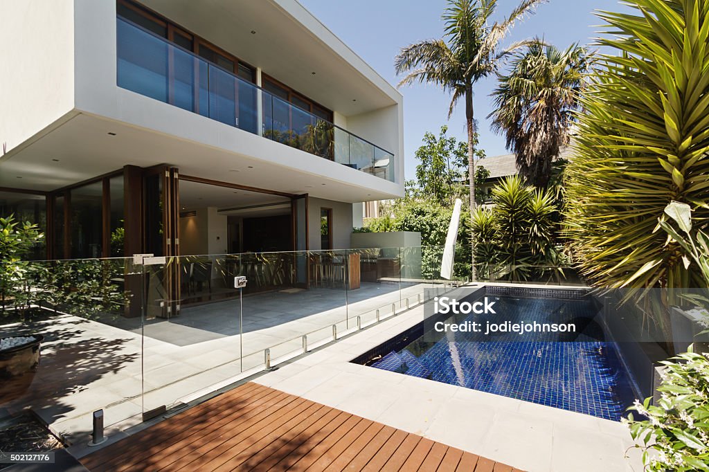 Rear garden of a contemporary Australian home with pool Rear garden of a contemporary Australian home with tiled swimming pool House Stock Photo